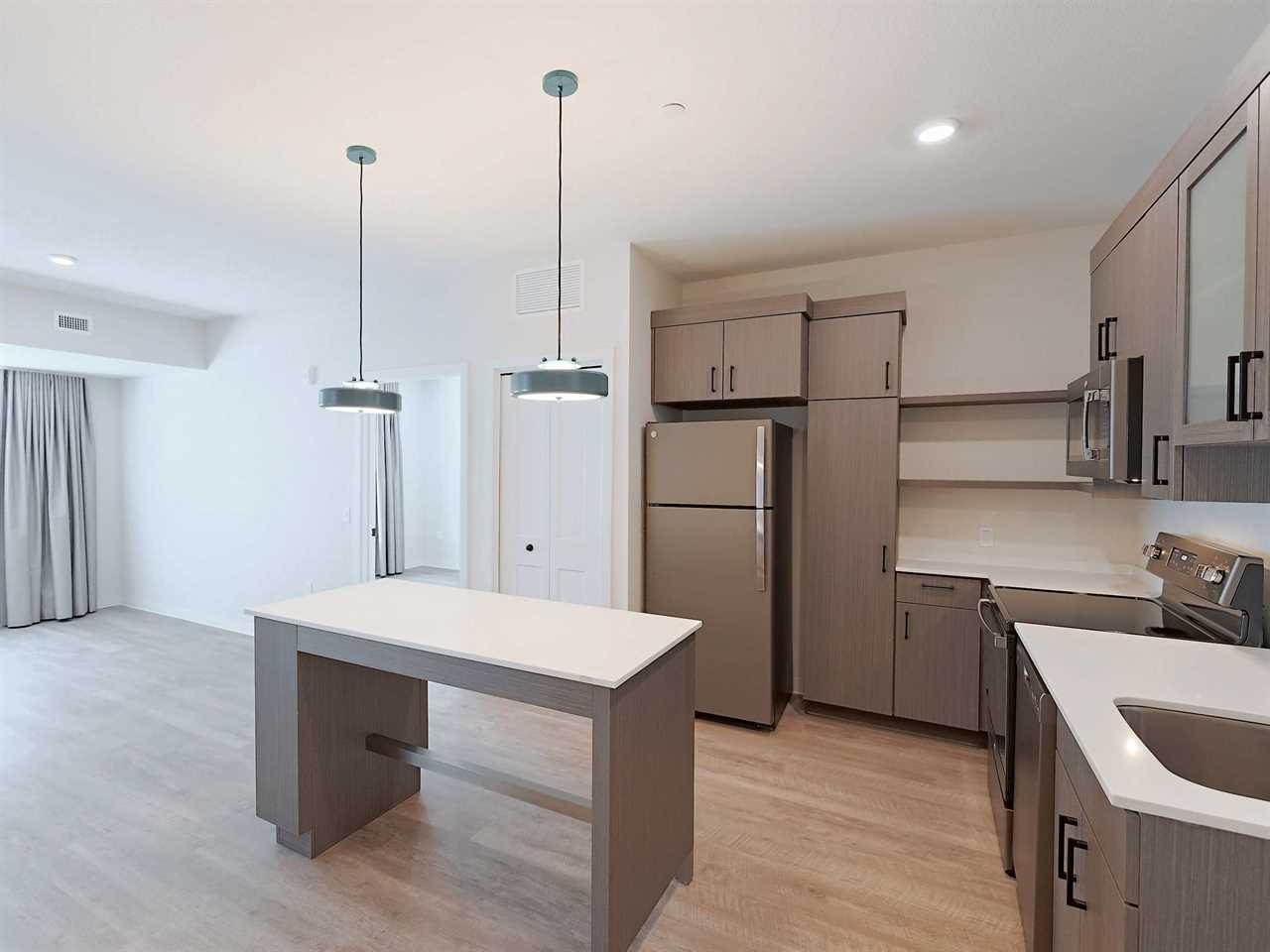 The kitchen of an unfurnished WaterWalk hotel room.