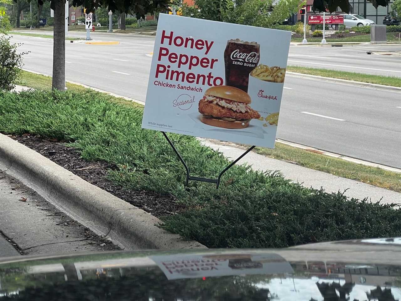 A sign promoting Chick-fil-A’s new honey pepper pimento chicken sandwich