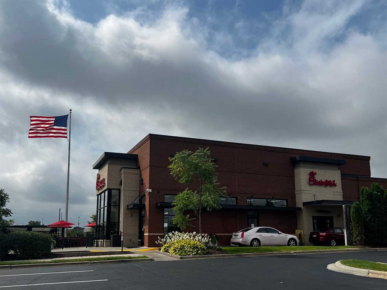 A Chick-fil-A restaurant with an American flag