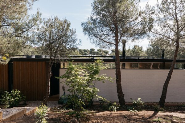 The prefabricated portion of the facade is built using corrugated, heat-treated wood.