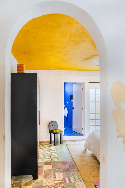 García used Behr paints throughout the house, including Turmeric for the bedroom ceiling. The black Sol chair from Chuch Estudio was inspired by a popular Mexican cookie.