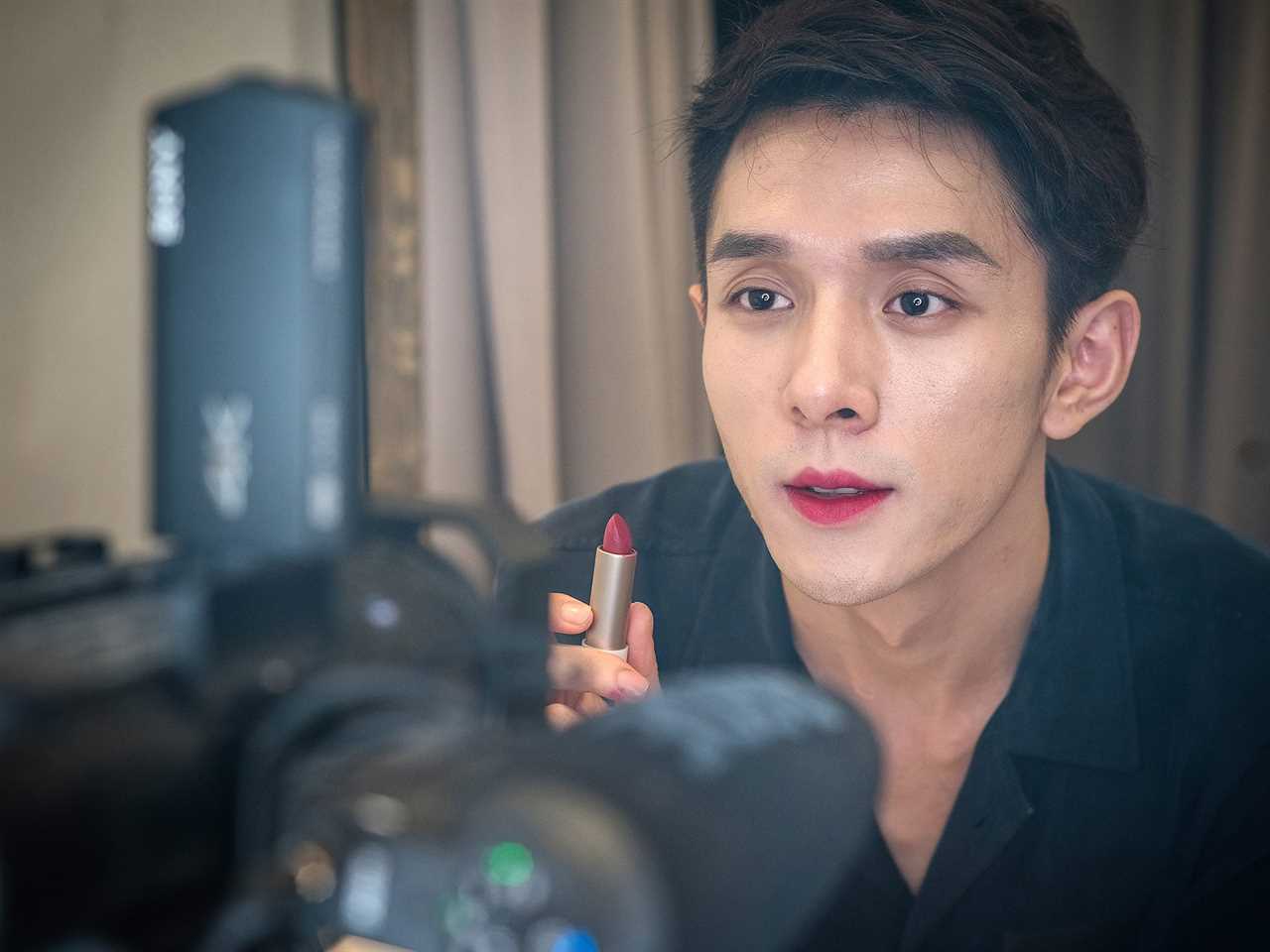 Beauty blogger Austin Li Jiaqi applies lipstick while livestreaming on the e-commerce platform Taobao on October 26, 2018 in Shanghai, China. 27-year-old man Austin Li Jiaqi, with a nickname 'Lipstick Brother', is the hottest online beauty blogger in China. Li sold 15,000 lipsticks in 5 minutes through livestreaming, beating Alibaba founder Jack Ma during a one-on-one competition as part of 2018 Alibaba 11.11 Global Shopping Festival.