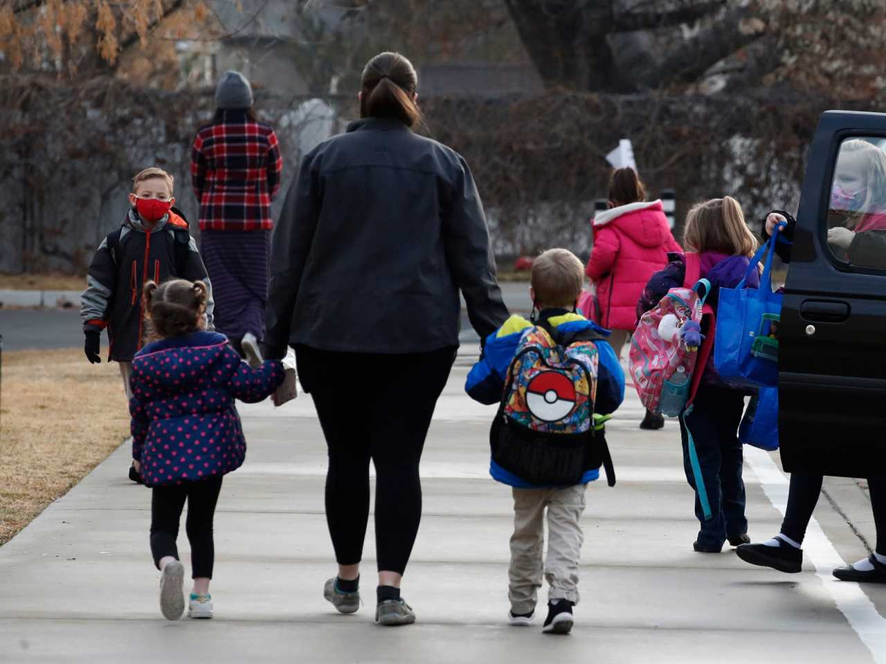 small children walking with an adults