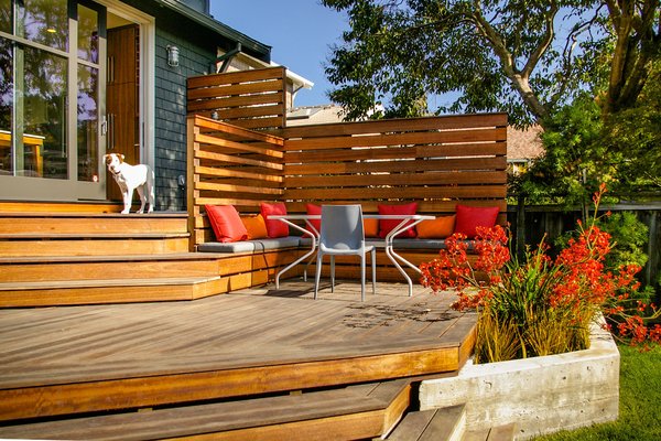 An eight-foot-high sliding glass door leads to the backyard's ipe deck, ideal for informal gatherings. The bench cushions are custom from Studio Collins Weir and the tables and chairs are from Design Within Reach.