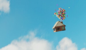 A house floating with balloons