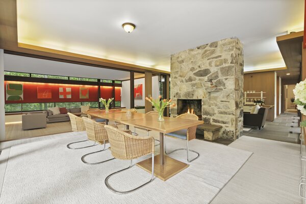 The steel fireplace in the dining area is framed with rescued stones from the dismantled garage during the original remodeling of the home.