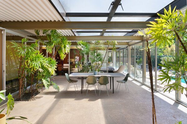 A more formal dining area can be found just steps from the kitchen in the glass-wrapped atrium.