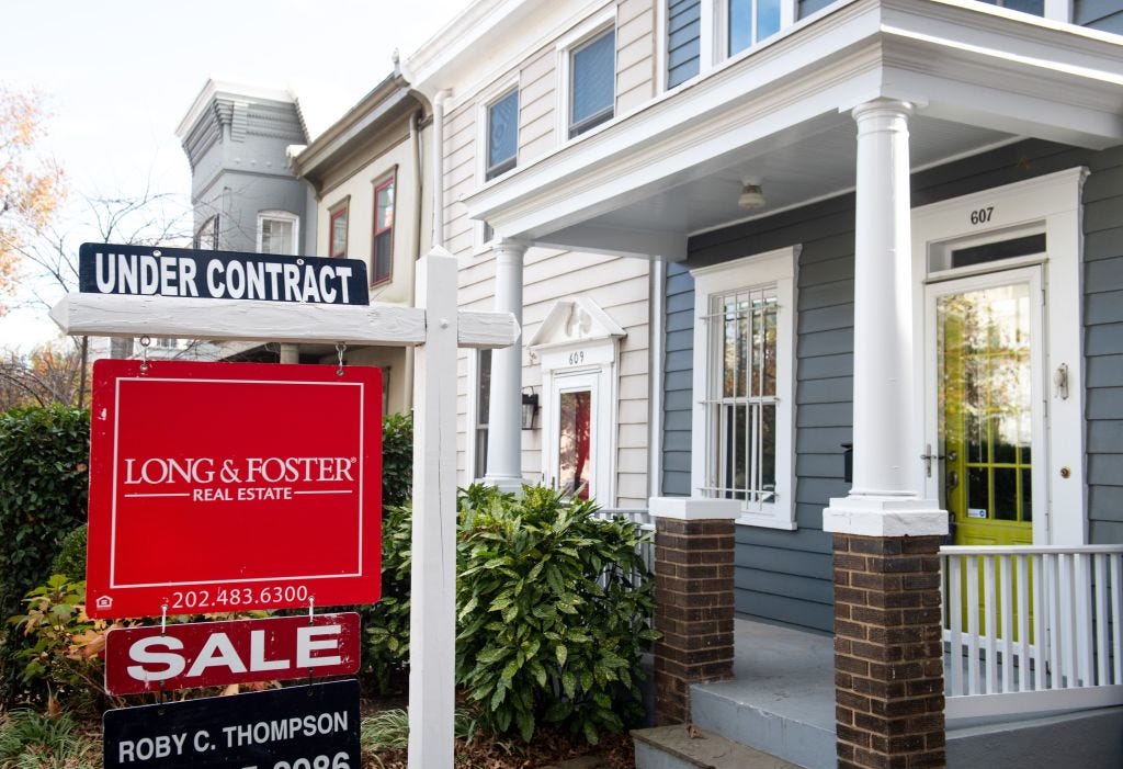 long and foster for sale sign under contract is in front of home