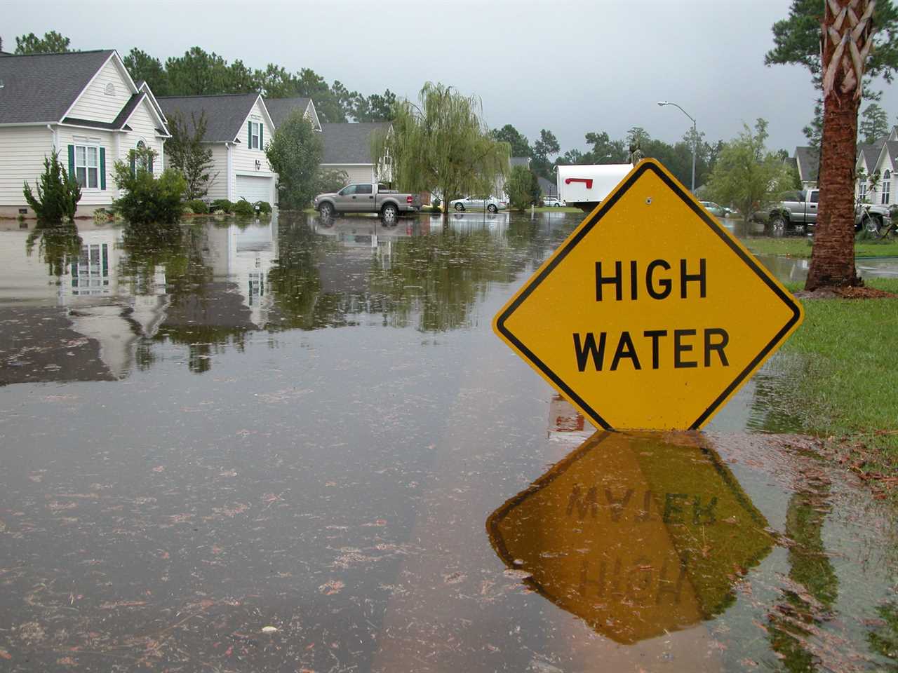 High Water sign in a flooded neighborhood