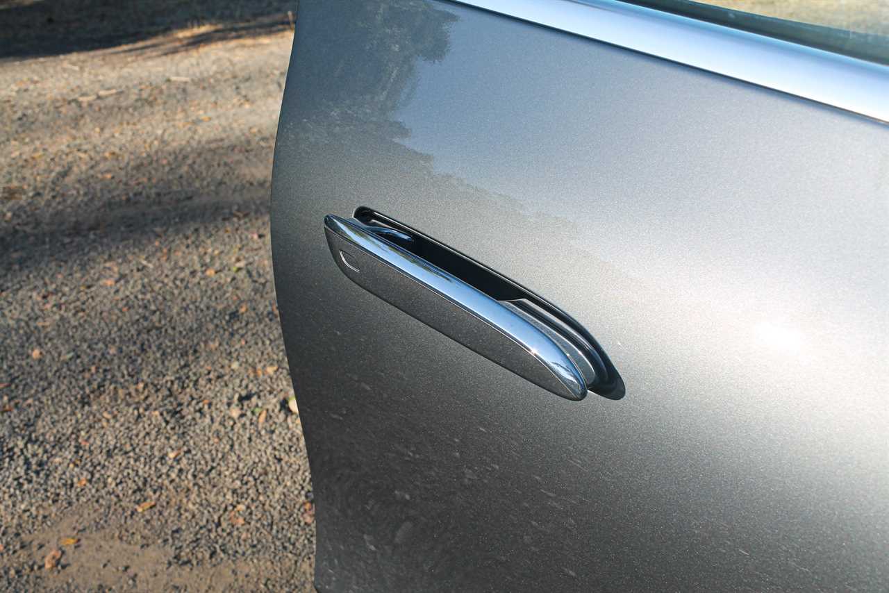 The door handle of a gray 2023 Mercedes-Benz EQE SUV. 