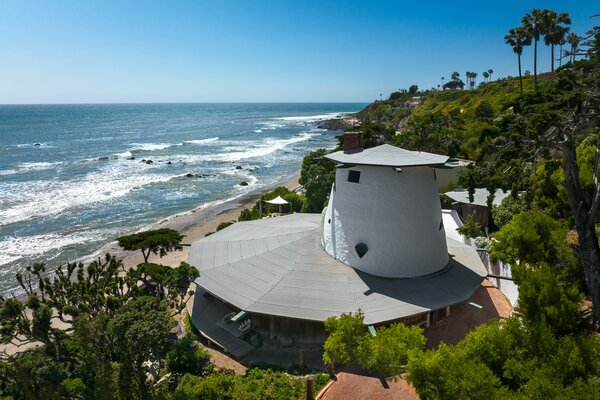 Perched just a few feet from the Malibu coastline, the home is named after its roofline, which was inspired by a sandcastle. The property includes 122 feet of private beachfront.