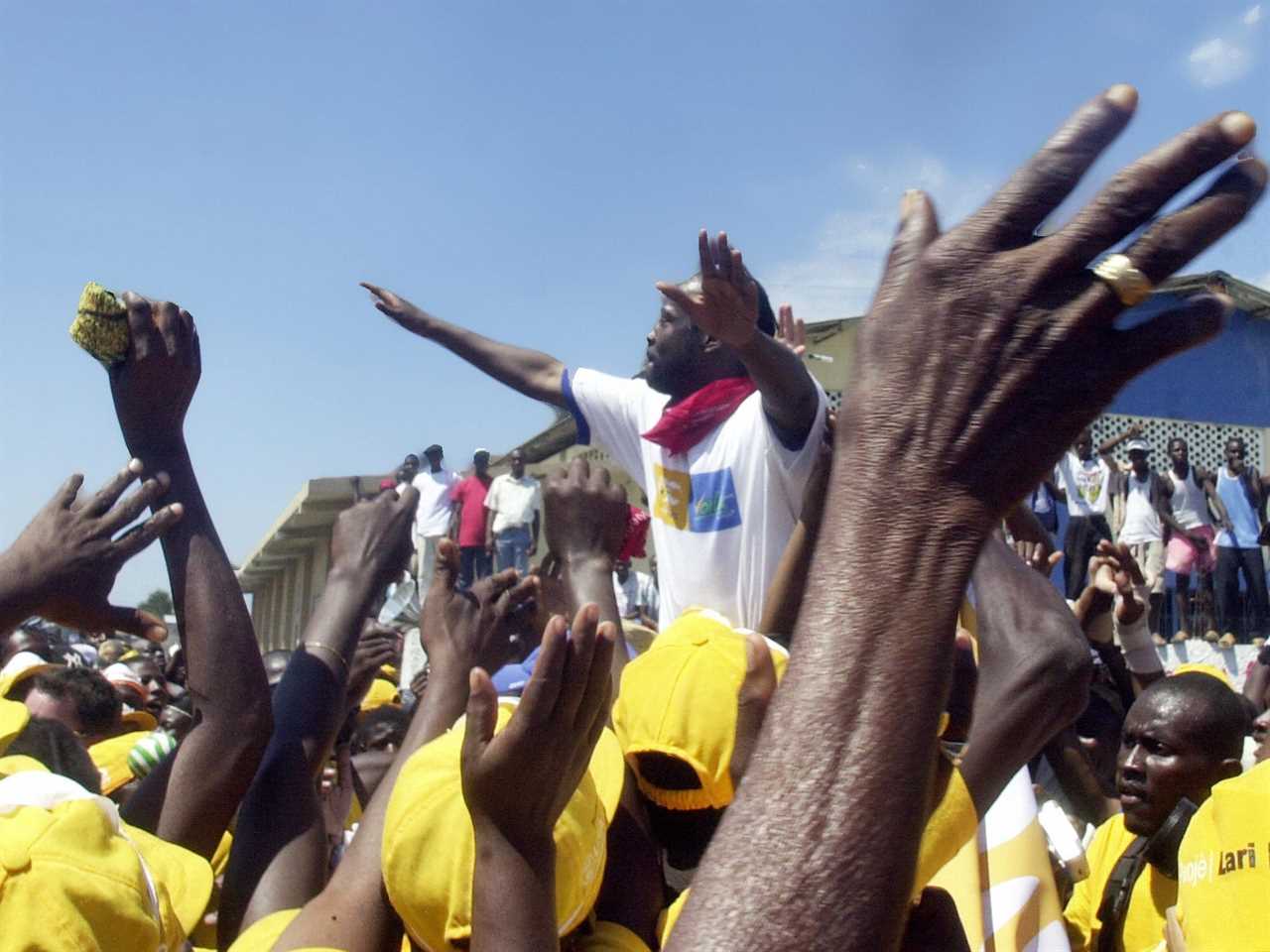 Port-au-Prince, HAITI: Haitian-American rapper Wiclef Jean is greeted by fans 02 March 2006 in the Cite Soleil slum of Port-au-Prince.