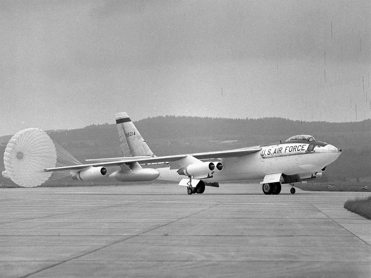 A B-47 Stratojet sits on a runway at  the International Air Meeting with a parachute trailing behind it