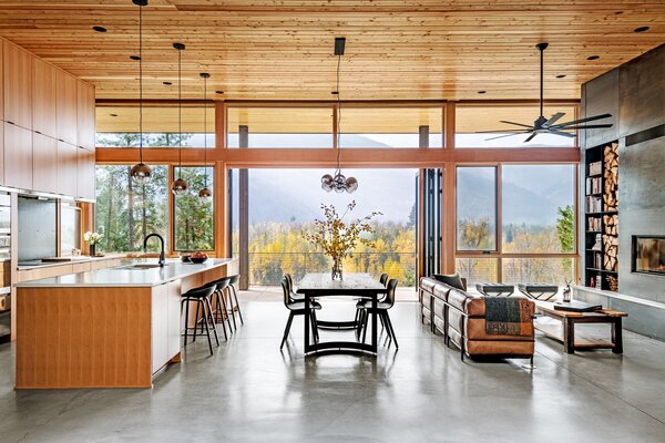 The couple loves to entertain, and the oversized kitchen island is the perfect place to prep. The countertop is quartz; the backsplash, hot-rolled steel. Barstools are from Pottery Barn. Lighting was sourced from West Elm.