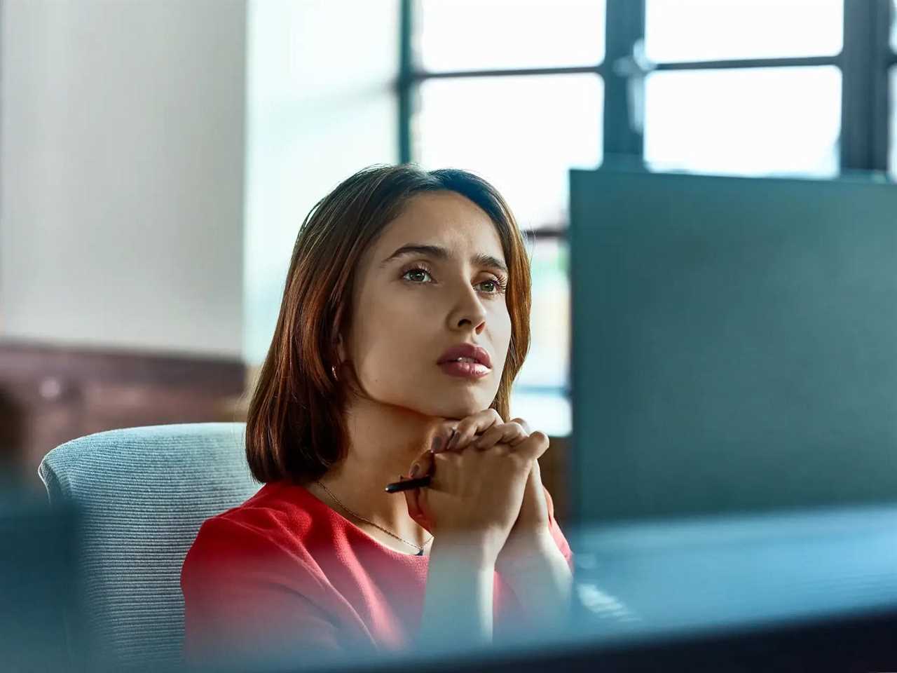 person staring blankly at a computer screen