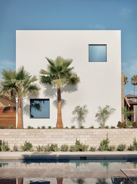 The west-facing facade of the detached garage and ADU. This structure anchors the east side of the property and creates a courtyard between itself and the main house.