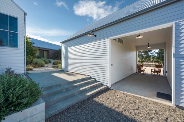 Breezeway separates the detached garage and guest suite, pathway leads to the front entry