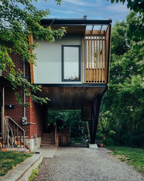 A cedar screen slides in front of the picture window to keep the glass protected during driveway basketball games. 