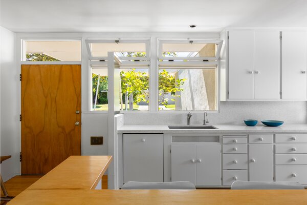 Upon entry is a bright, airy kitchen, complete with original cabinetry and new appliances.