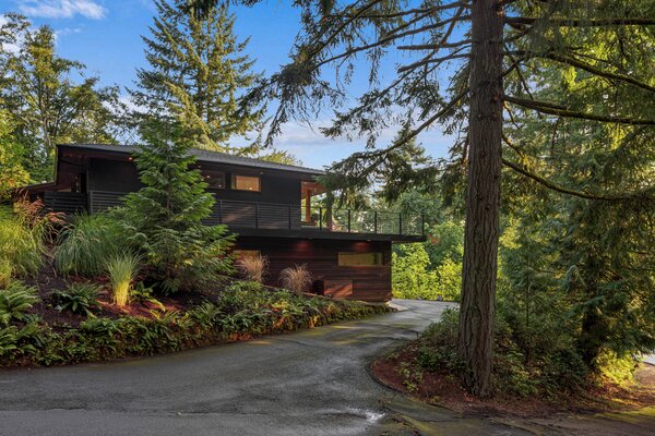 The revived home sits in a secluded, wooded neighborhood that adjoins Forest Park. A massive trail system, including a trailhead, is just a short walk from the property.