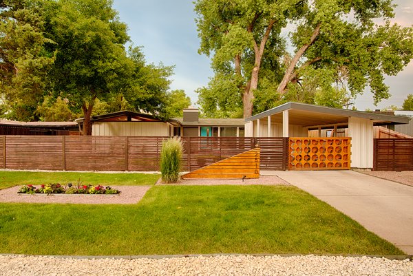 From the street, large trees provide shade to the private courtyard in the summer. A unique remote-controlled gate has been added to the house’s original carport. A new address monument matches the angle of the house’s roof.