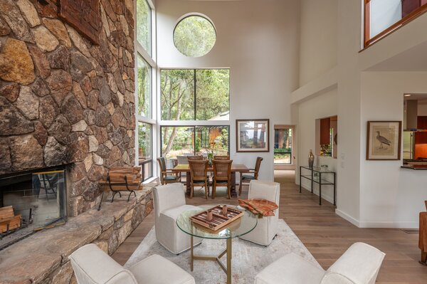 A floor-to-ceiling stone fireplace anchors the living areas, complete with expansive glazing.