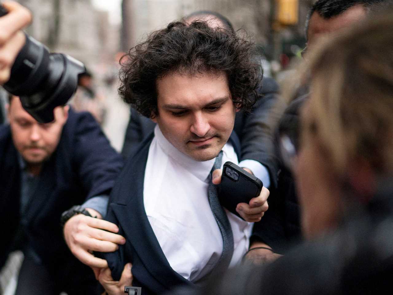 Sam Bankman-Fried arrives off-balance amid a scrum of photographers at Manhattan Federal Court on February 16.