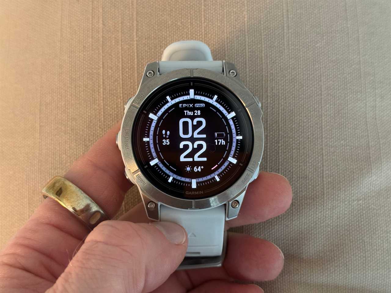 Someone holding a Garmin Epix Pro smartwatch in their hand.