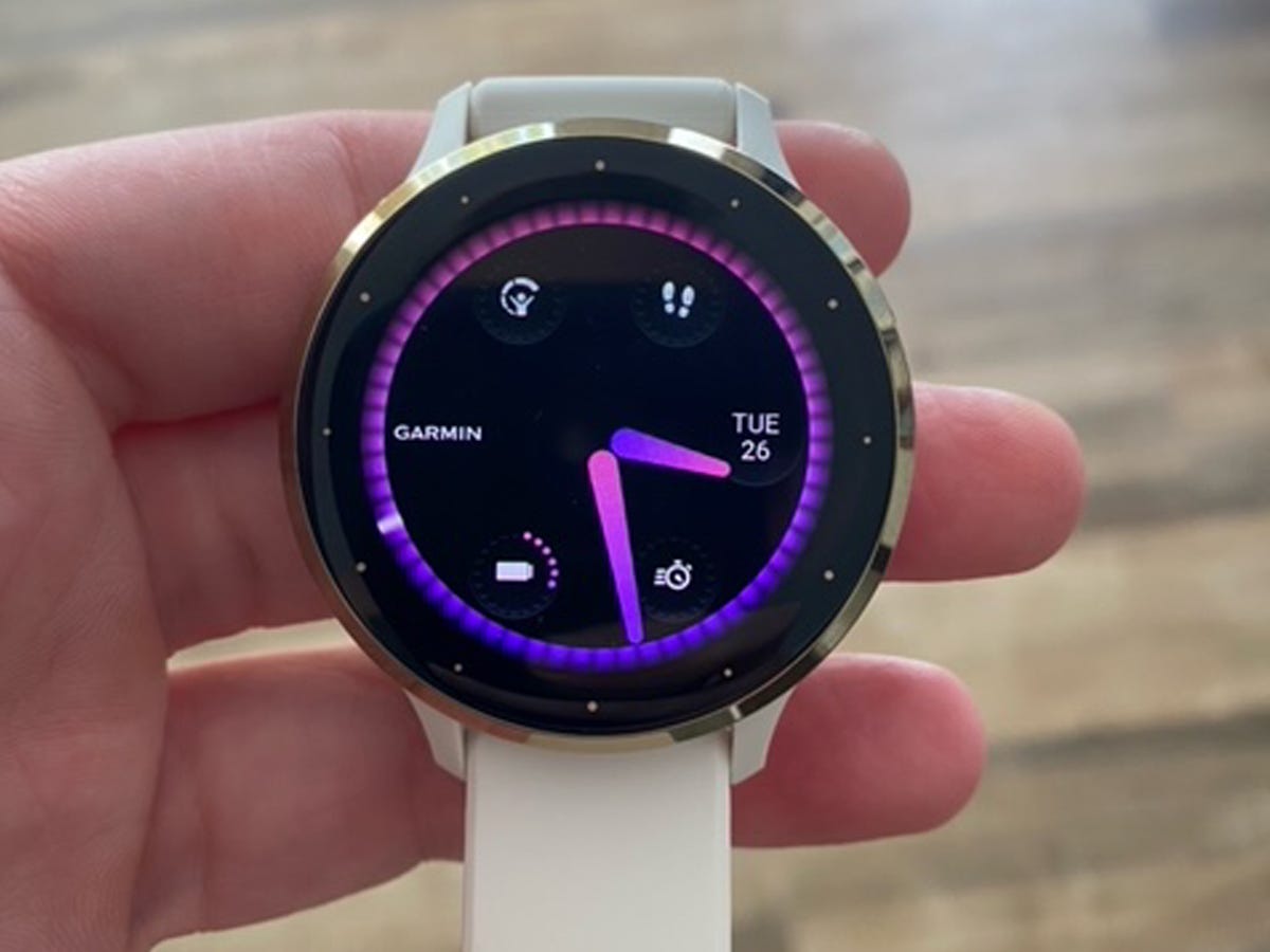 Someone holding a Garmin Venu 3 smartwatch in their hand.