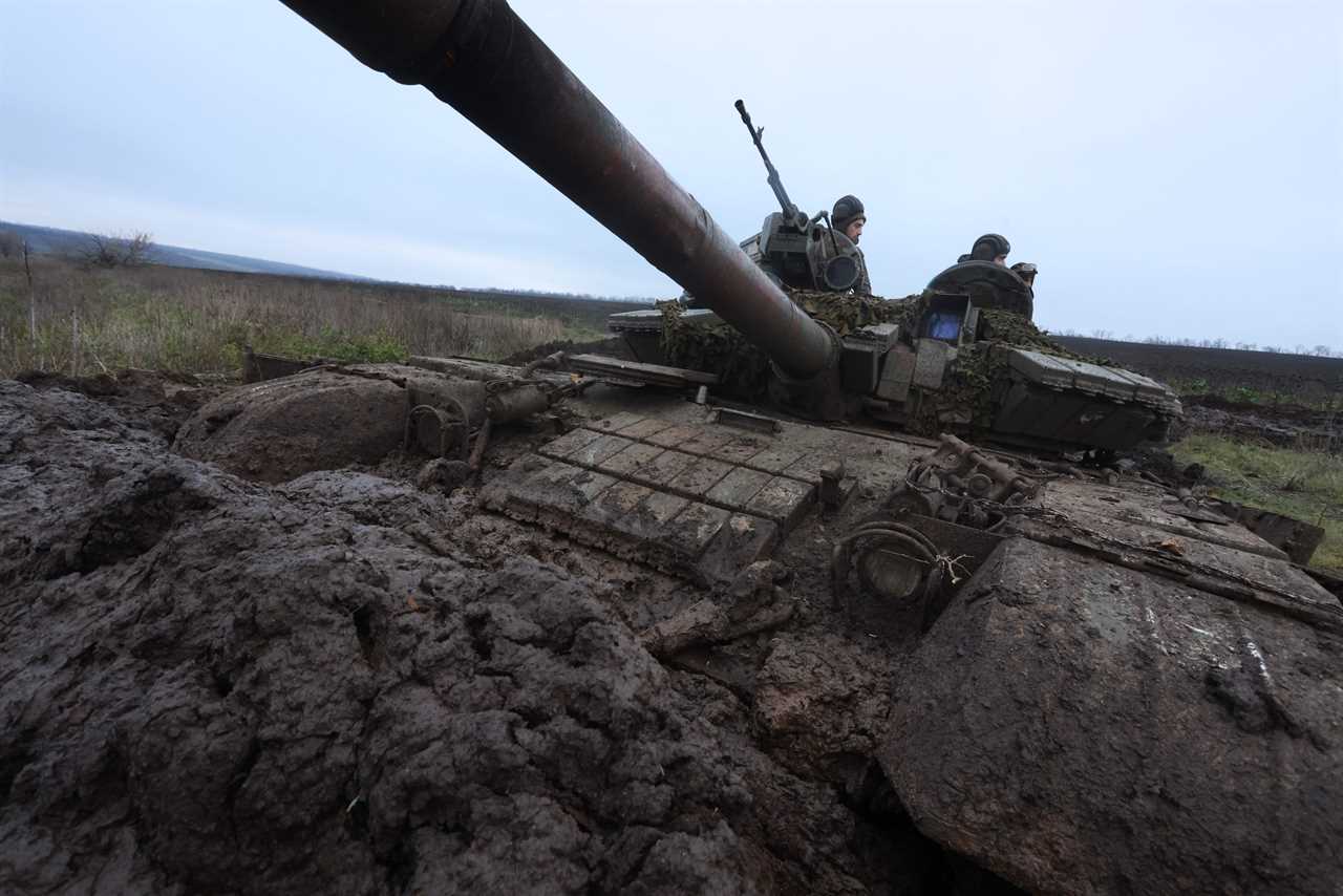 Ukrainian tankers man their positions atop a tank in a muddy field near an undisclosed frontline position in eastern Ukraine on November 28, 2022, amid the Russian invasion of Ukraine.