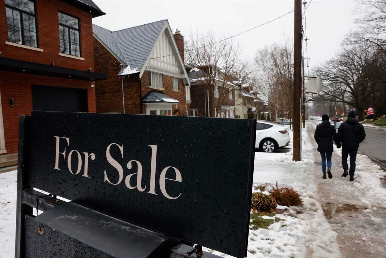 A house for sale sign is displayed outside a property.