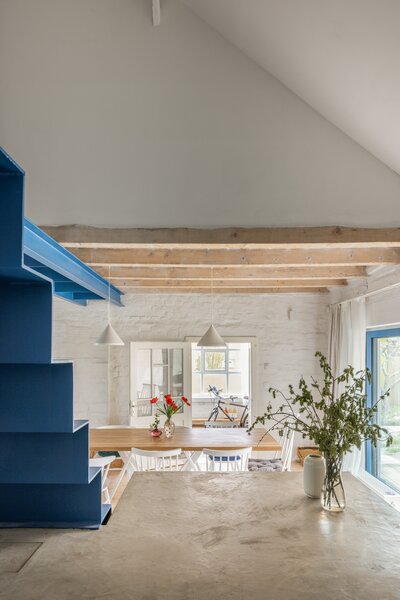 A Blue Stair Steps Up a Filmmaker’s Renovated Brick Home in Slovakia