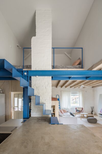 A Blue Stair Steps Up a Filmmaker’s Renovated Brick Home in Slovakia