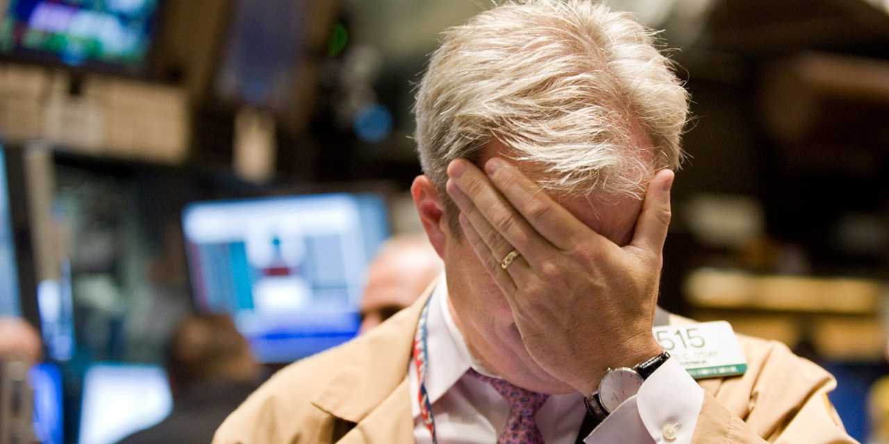 nyse trader hand on face