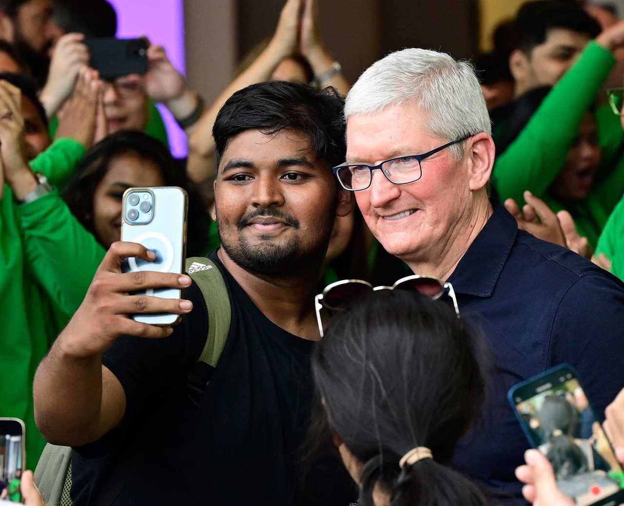 Apple CEO Tim Cook gets selfie with visitors, during inauguration of "Apple Store", first outlet opened in India, at Bandra-Kurla Complex on April 18, 2023 in Mumbai, India.