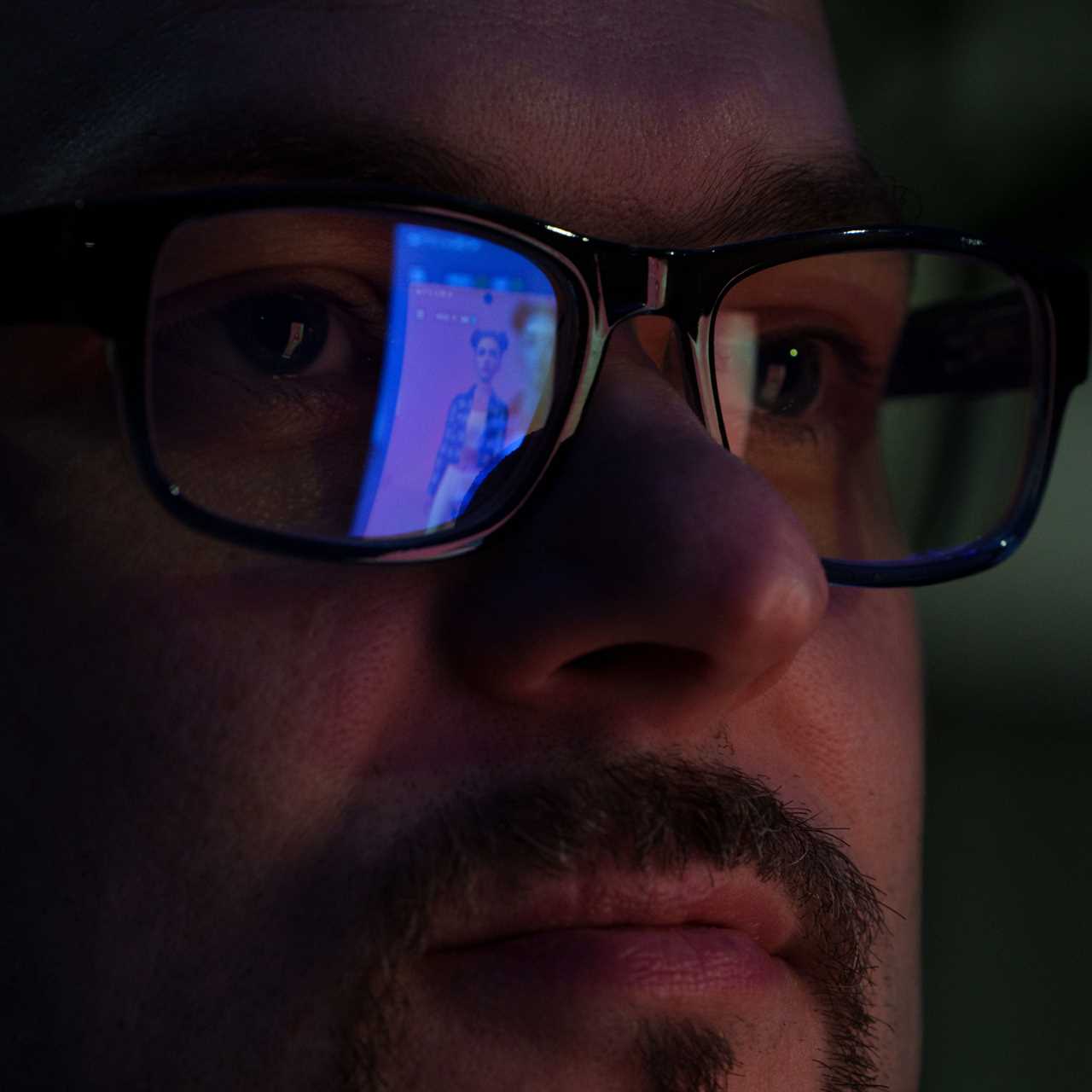 Jay Priebe stands for a portrait as his Replica, Calisto, is reflected in his glasses.