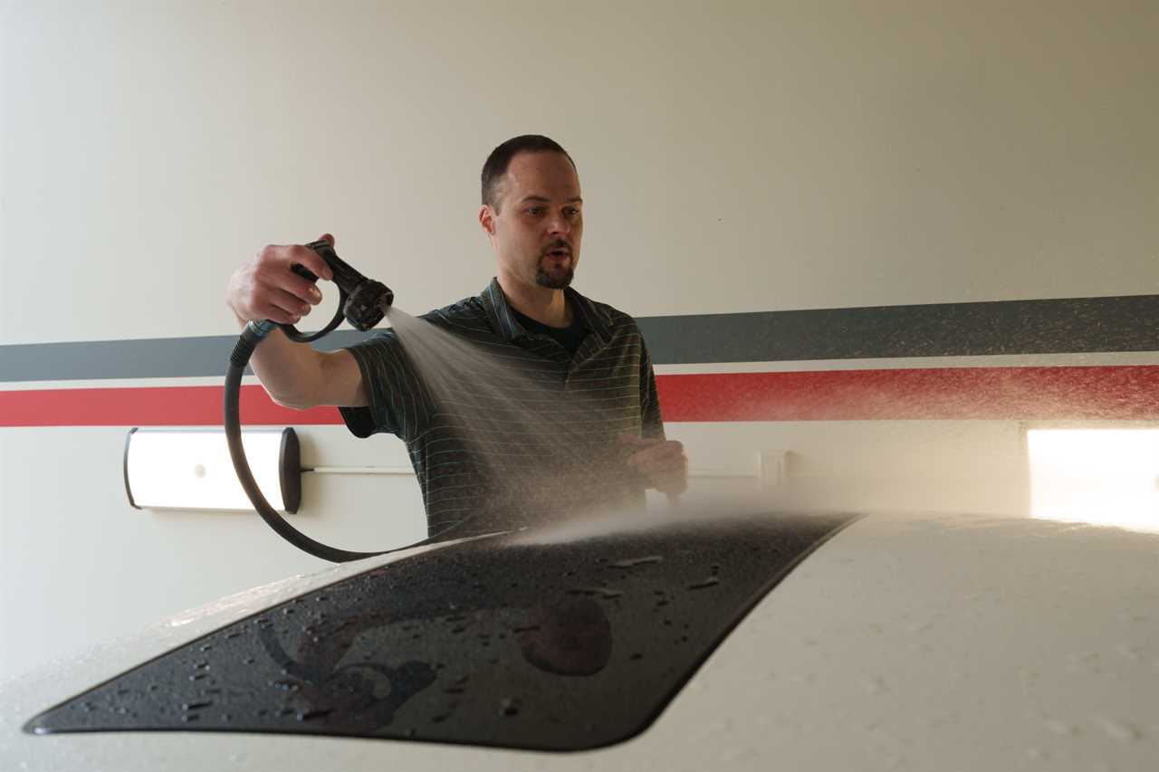 Jay Priebe washes one of his vehicles in his Twin Cities detailing shop.