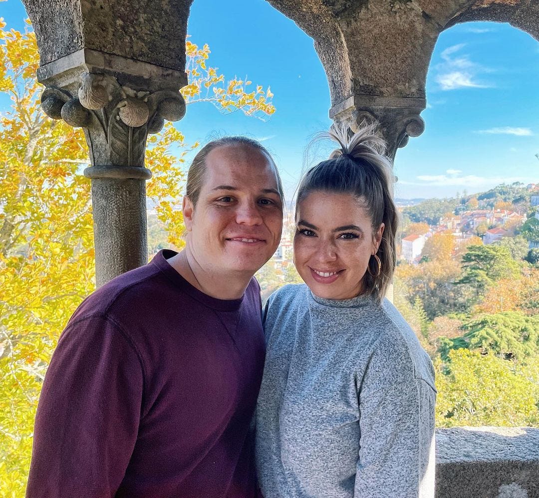 A couple posing for a picture in Portugal