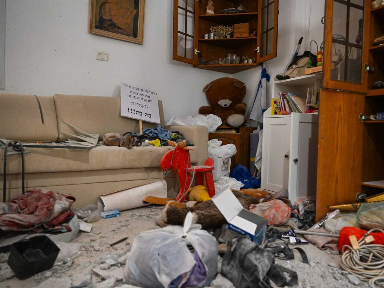 Family belongings including teddy bears, and the Judaica shelf at a home in Kibbutz Be'eri near the Gaza border after Hamas militants attacked on October 7.