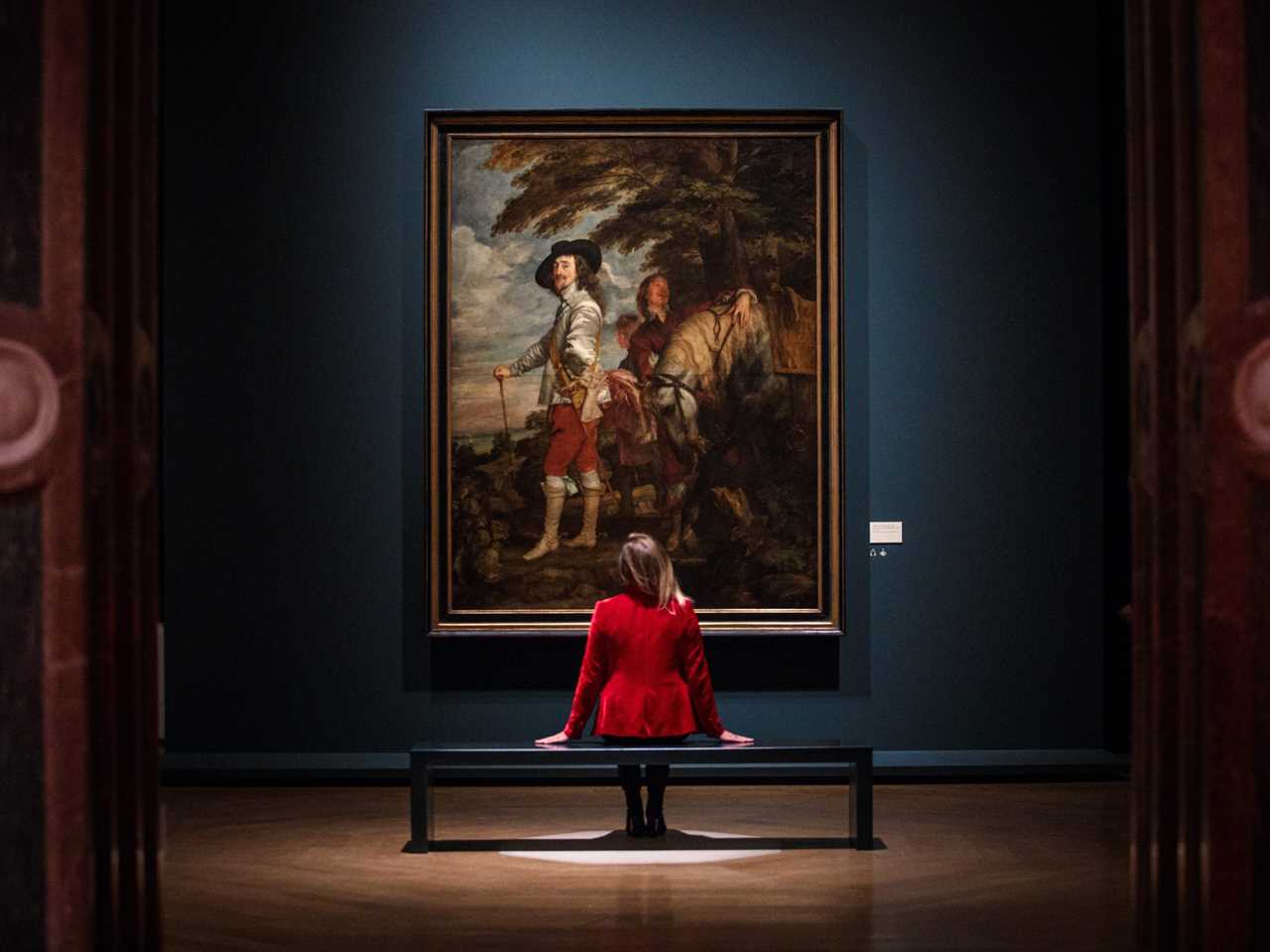 An employee in front of "Charles I in the Hunting Field," by Anthony van Dyck, during a press preview at the Royal Academy of Arts.