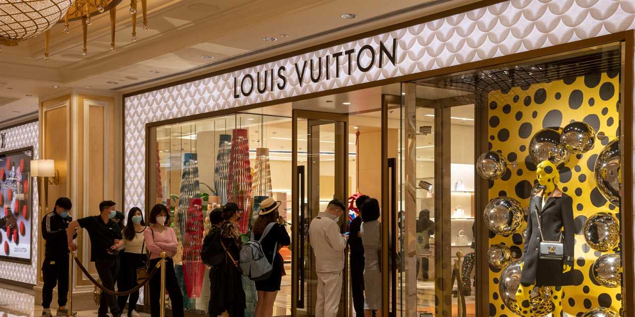 Chinese tourists buying the luxury brand Louis Vuitton, Macau, China.