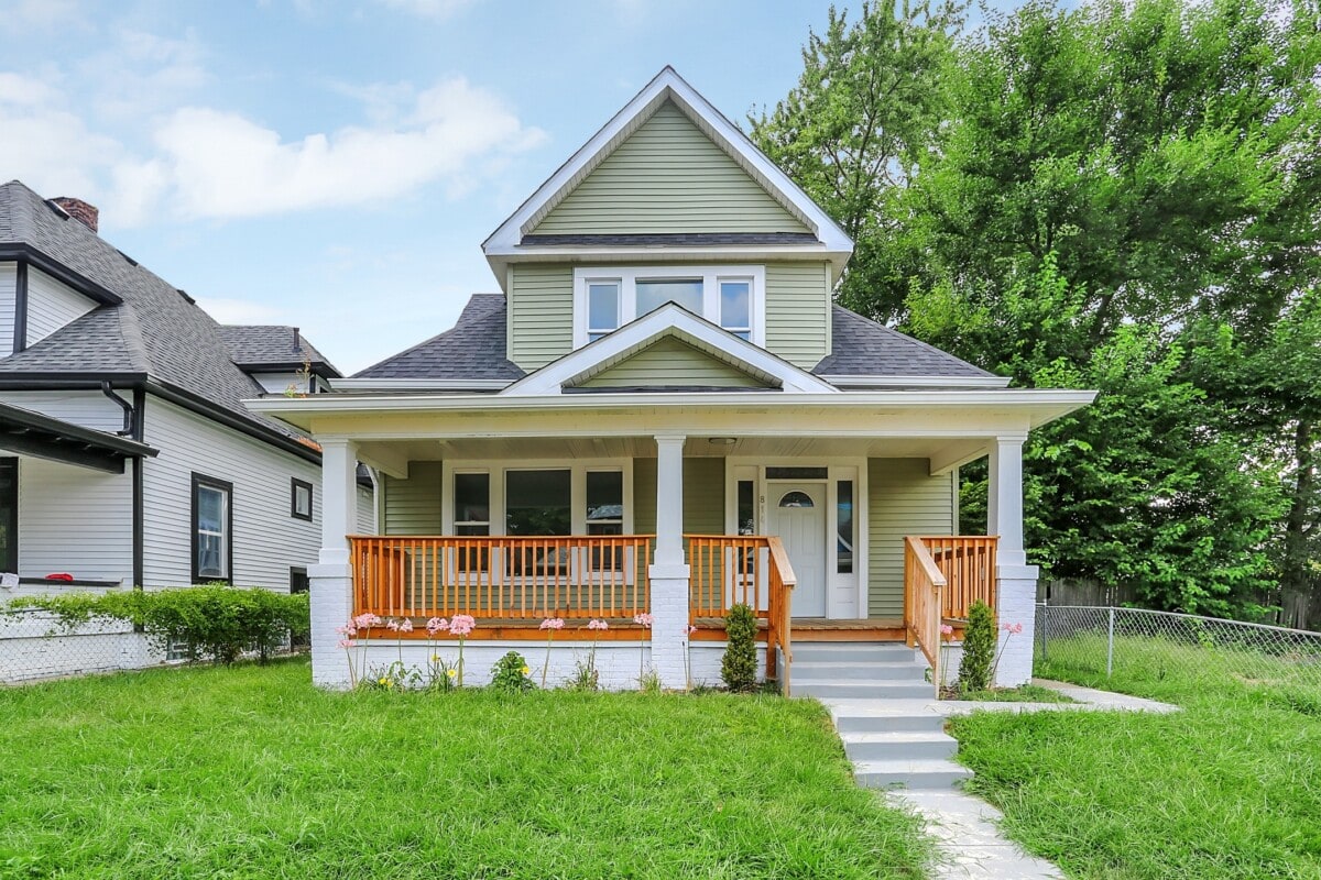 sage green home in Indianapolis Indiana with porch and green lawn