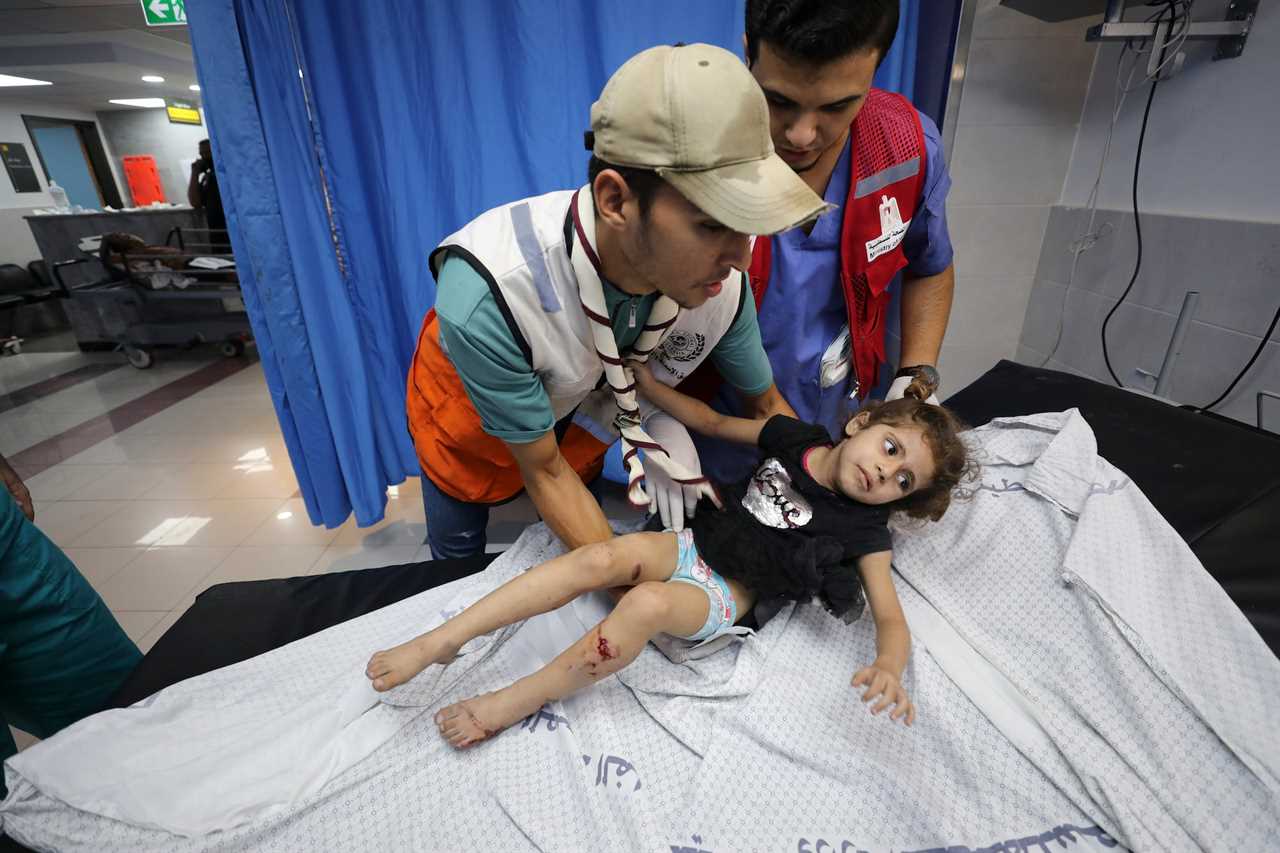 Palestinian child wounded in Israel strikes are brought to Shifa Hospital in Gaza City