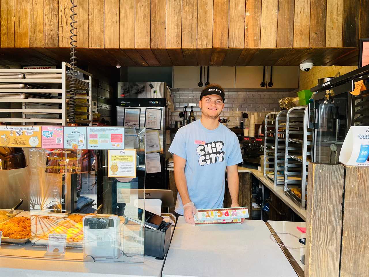 a Chip City employee smiles while serving cookies