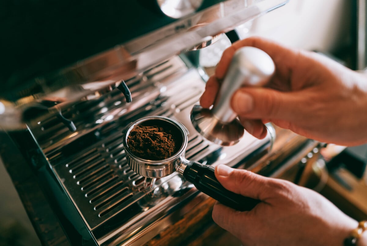 Person preparing an espresso shot