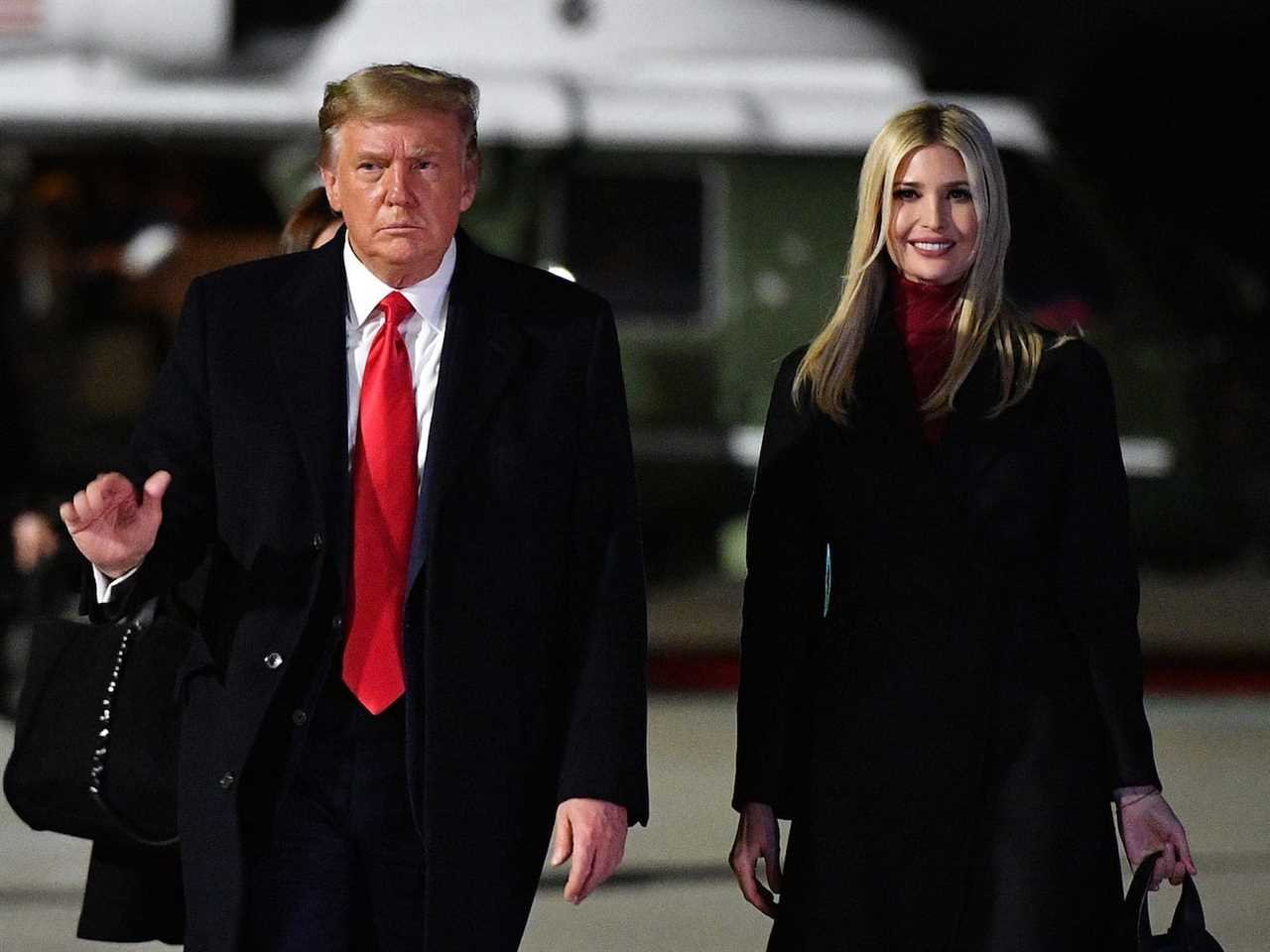 Donald Trump, who is wearing a black suit with a red tie, walking toward Air Force One with Ivanka Trump, who is smiling and wearing a burgundy turtleneck and a long black coat.