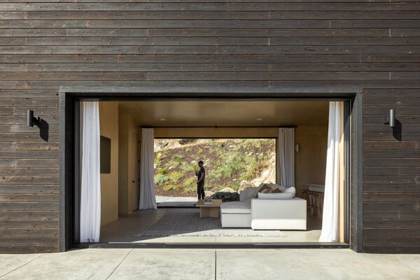 Two large openings flank the east and west sides of the home, offering expanded indoor-outdoor living and cross ventilation.