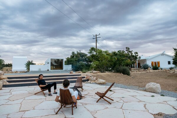 Friends gather at the firepit off the pool.