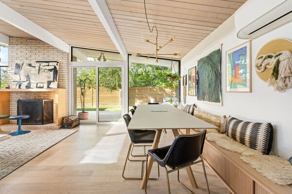 A handcrafted bench (which doubles as storage) stretches across the open dining area.