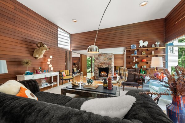 A striking blend of wood, glass, and stone awaits in the light-filled main living areas.